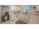 Bright kitchen features white cabinets, a gas range, and a window over the sink at 1327 Rupert Rd, Decatur, GA 30030