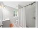 Bathroom features new shower with tiled walls, toilet, vanity, and natural light from the window at 1735 Carter Cir, Atlanta, GA 30344