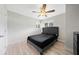 Bedroom features light wood flooring, fan, and a tufted headboard, offering a calming and stylish space at 1735 Carter Cir, Atlanta, GA 30344