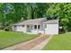 Charming single-story home featuring a well-maintained lawn, painted brick, and a cute front porch at 1735 Carter Cir, Atlanta, GA 30344
