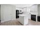Kitchen with an island, stainless steel appliances and white cabinetry at 1735 Carter Cir, Atlanta, GA 30344