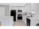 Modern kitchen with new stainless steel appliances, white cabinetry, and laminate flooring at 1735 Carter Cir, Atlanta, GA 30344