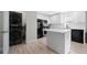 Modern kitchen with white cabinets, stainless steel appliances, an island, and washer/dryer combo at 1735 Carter Cir, Atlanta, GA 30344