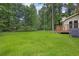 Backyard featuring lush lawn and wooded border at 6503 Tent Valley Dr, Riverdale, GA 30296