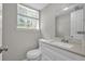 Bright bathroom features a white vanity with a light countertop and natural light from the window at 6503 Tent Valley Dr, Riverdale, GA 30296