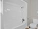Clean, white shower and toilet in a bathroom with tile floors and gray walls at 6503 Tent Valley Dr, Riverdale, GA 30296