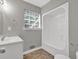 Bright bathroom with a white vanity, tub/shower combo and a window at 6503 Tent Valley Dr, Riverdale, GA 30296