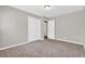 Bedroom with neutral walls, double closet doors, and tan carpet at 6503 Tent Valley Dr, Riverdale, GA 30296