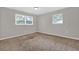 Bedroom featuring carpet, neutral walls, and natural light from a large window at 6503 Tent Valley Dr, Riverdale, GA 30296