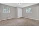 Bedroom featuring two windows, neutral walls and carpeted floor at 6503 Tent Valley Dr, Riverdale, GA 30296