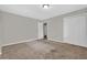 Carpeted bedroom with closet and grey paint at 6503 Tent Valley Dr, Riverdale, GA 30296