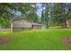 Charming home showcasing a lush green lawn, mature trees and inviting curb appeal at 6503 Tent Valley Dr, Riverdale, GA 30296