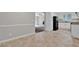 The kitchen leads into the living room, and features white cabinets, laminate counters, and black appliances at 6503 Tent Valley Dr, Riverdale, GA 30296