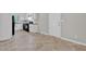 This kitchen features white cabinets, black appliances, laminate countertops, and vinyl flooring at 6503 Tent Valley Dr, Riverdale, GA 30296