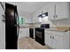 The kitchen features white cabinets, a black range, and stainless steel dishwasher at 6503 Tent Valley Dr, Riverdale, GA 30296
