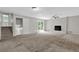 Large living room features a brick fireplace, ceiling fan, and sliding glass doors to the backyard at 6503 Tent Valley Dr, Riverdale, GA 30296