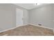 A tiled room featuring a white door, light-colored walls, and baseboard trim around the perimeter at 6503 Tent Valley Dr, Riverdale, GA 30296