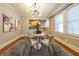 Dining area featuring modern lighting, a breakfast bar pass-through to kitchen, and hardwood floors at 2 Collier Nw Rd # 5, Atlanta, GA 30309