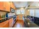 Galley kitchen with stainless appliances, wood cabinets, granite counters and hardwood floors at 2 Collier Nw Rd # 5, Atlanta, GA 30309