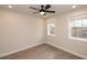 Bedroom with neutral walls, black ceiling fan, two windows, and wood-look flooring at 540 Fisher Dr # 46, Alpharetta, GA 30009