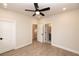 This bedroom includes a ceiling fan, plank flooring, neutral walls, and a view of the bathroom at 540 Fisher Dr # 46, Alpharetta, GA 30009