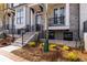 Charming brick townhome featuring a front porch, landscaped garden and black metal railings at 540 Fisher Dr # 46, Alpharetta, GA 30009