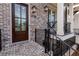 Charming brick townhome featuring a front porch and black metal railings at 540 Fisher Dr # 46, Alpharetta, GA 30009