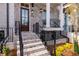 Charming brick townhome featuring a front porch, landscaped garden and black metal railings at 540 Fisher Dr # 46, Alpharetta, GA 30009