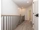 Well-lit hallway with modern wood floors, sleek railings, and white paneled walls leading to other rooms at 540 Fisher Dr # 46, Alpharetta, GA 30009