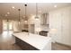 Bright, open kitchen featuring a large island, stainless steel hood, and modern pendant lighting at 540 Fisher Dr # 46, Alpharetta, GA 30009