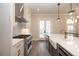 Well-lit kitchen featuring white cabinetry, a stainless steel range and farmhouse sink at 540 Fisher Dr # 46, Alpharetta, GA 30009
