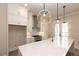 Bright, open kitchen featuring a large island, stainless steel hood, and modern pendant lighting at 540 Fisher Dr # 46, Alpharetta, GA 30009