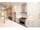 Bright kitchen featuring white cabinetry, stainless steel appliances, herringbone backsplash and pendant lighting at 540 Fisher Dr # 46, Alpharetta, GA 30009