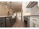 Open-concept kitchen with a stainless steel dishwasher and range, granite countertops and pendant lights at 540 Fisher Dr # 46, Alpharetta, GA 30009