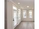 Inviting living room bathed in natural light from multiple windows and a glass door, complemented by light wood-style flooring at 540 Fisher Dr # 46, Alpharetta, GA 30009