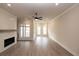Large living room with a fireplace and three windows providing natural light at 540 Fisher Dr # 46, Alpharetta, GA 30009