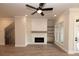 Well-lit living room features a fireplace, shelving, and an open staircase for easy access at 540 Fisher Dr # 46, Alpharetta, GA 30009