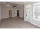 Open-concept room with light wood-style floors and a trey ceiling, seamlessly connected to multiple doorways and outdoor access at 540 Fisher Dr # 46, Alpharetta, GA 30009