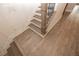 View of a staircase with light wood stairs and black iron balusters, complemented by light wood-style flooring at 540 Fisher Dr # 46, Alpharetta, GA 30009
