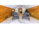 Finished attic featuring wood paneled walls, plush carpet, and sitting area perfect for relaxing or entertaining at 570 Park Se Ave, Atlanta, GA 30312