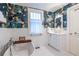 Elegant bathroom with modern vanity, a standalone tub, and stylish wallpaper accent at 570 Park Se Ave, Atlanta, GA 30312