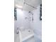 Well-lit bathroom showcasing a modern shower, soaking tub, tropical wallpaper, and subway tiles at 570 Park Se Ave, Atlanta, GA 30312