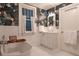 The bathroom includes a standalone tub, patterned wallpaper and a white vanity at 570 Park Se Ave, Atlanta, GA 30312