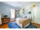 Comfortable bedroom with a blue accent rug, hardwood floors, and bright natural light at 570 Park Se Ave, Atlanta, GA 30312
