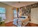 This bedroom features vibrant wall decor, hardwood floors, and sun-filled windows at 570 Park Se Ave, Atlanta, GA 30312
