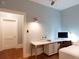 Bedroom with blue walls featuring built-in desk, sewing machine and laundry area at 570 Park Se Ave, Atlanta, GA 30312