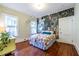 Stylish bedroom features unique wallpaper, hardwood floors, and lots of natural light at 570 Park Se Ave, Atlanta, GA 30312