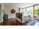 Cozy bedroom featuring hardwood floors, stylish furnishings, large windows with decorative curtains, and a decorative rug at 570 Park Se Ave, Atlanta, GA 30312