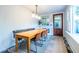 Bright dining area features a built-in banquette, rug, modern lighting, and entry door at 570 Park Se Ave, Atlanta, GA 30312