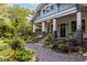 Charming home with a covered porch, lush landscaping, and a gravel pathway leading to the front door at 570 Park Se Ave, Atlanta, GA 30312